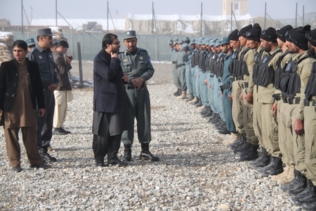 Guvernér provincie Lógar Mohammad Iqbal Azizi (v tmavém obleku) hovoří s úspěšnými absolventy základního kurzu policistů Afghánské národní policie.