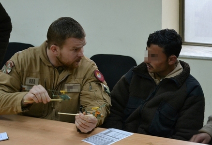 WO Milan R. explains procedures before testing of helicopter weapons to his Afghan colleague