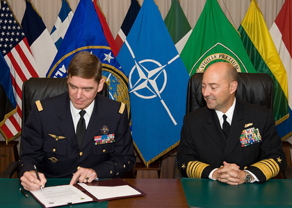 General Stéphane Abrial and Admiral J. Stavridis sign the document