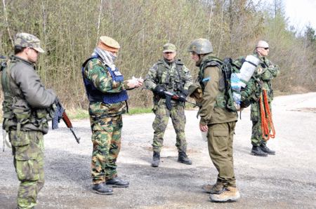 Velitel skupiny se snaží vyjednat s vojáky průchod přes jejich kontrolní stanoviště