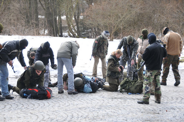 Během chvilky se kolem novinářů seběhla banda neurvalých  ozbrojenců, kteří se, jak se zdá, neštítí ničeho...