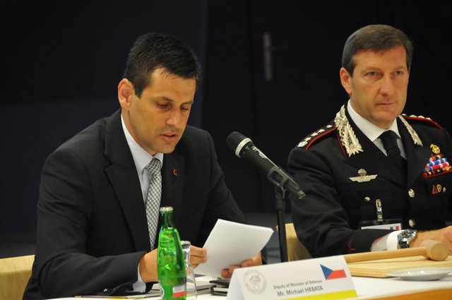 Náměstek ministra obrany Michael Hrbata při projevu, vpravo předsedající italský plukovník Fabrizio Parrulli