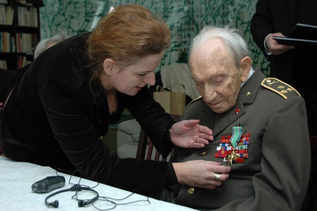 Náměstkyně ministra obrany pro personalistiku připevňuje Gustavu Singerovi na uniformu resortní vyznamenání