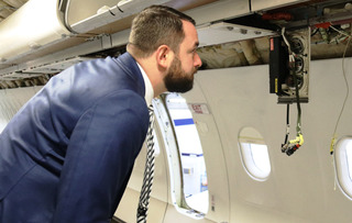  Filip Říha si prohlíží jeden z rozebraných detailů letounu