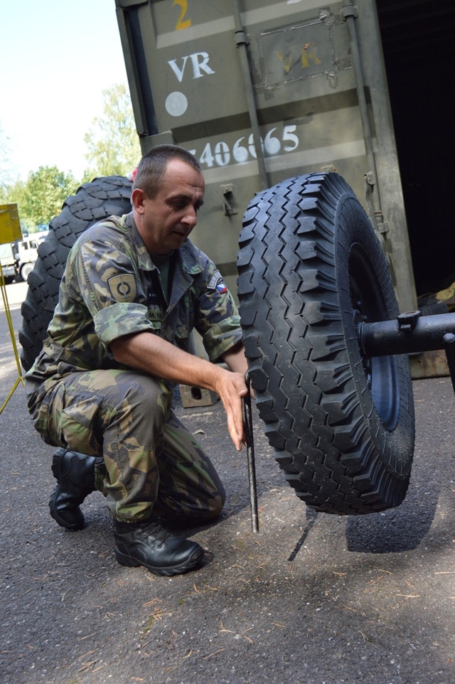 Soutěžící demontuje kolo automobilu UAZ-469 na čas