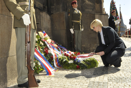 A symbolicky urovnává stuhy na věnci