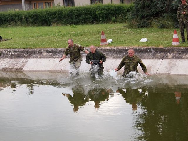 Čeští výsadkáři se vrhají do vodní překážky.