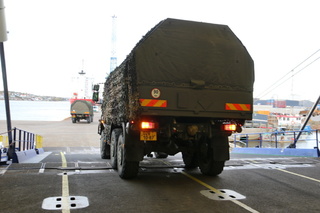 České vojenské vozy sjíždí do přístavu