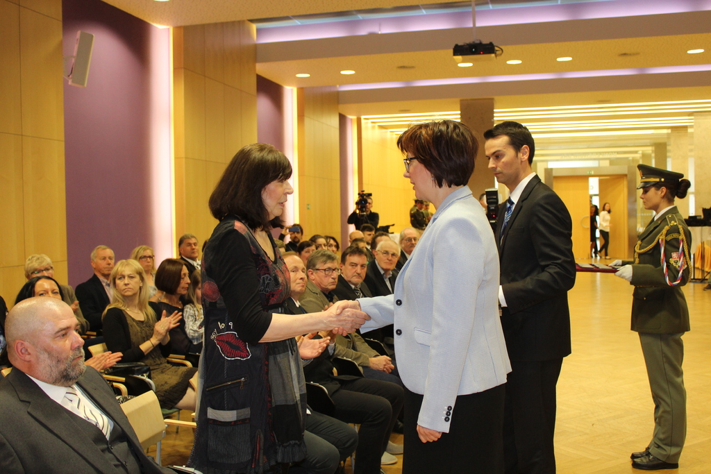 Zdeňka Gruntorádová přebírá osvědčení za rozmnožování a distribuci samizdatových tiskovin, zejména knih ediční řady Popelnice, a dále za poskytování zázemí a udržování kontaktů nezbytných pro podporu protirežimních aktivit