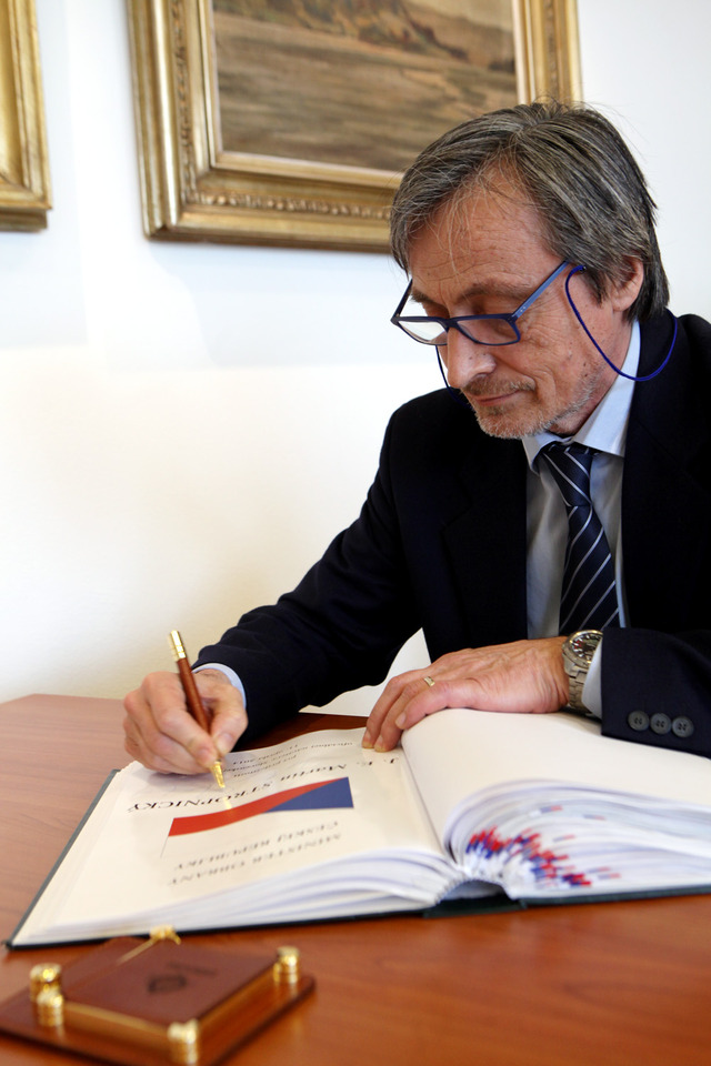 Martin Stropnický se podepisuje do knihy návštěv