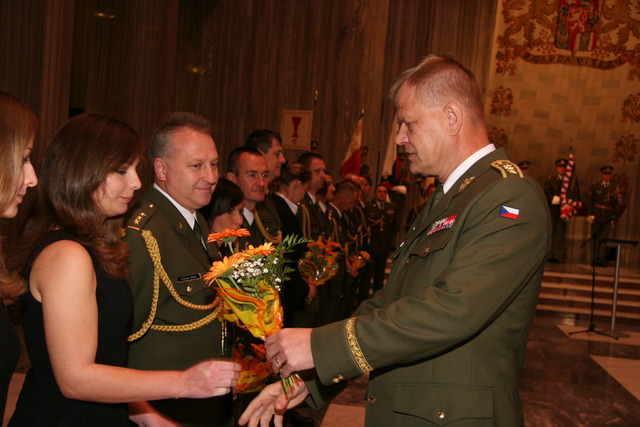 ...a poté předal květiny manželkám nových plukovníků