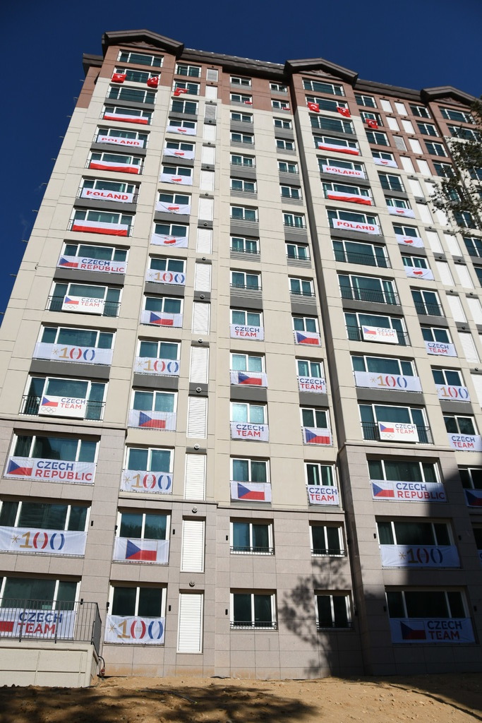 Jeden z domů olympijské horské vesnice. Sedm pater obývají Češi