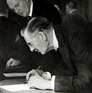 Britský premiér Neville Chamberlain podepisuje Mnichovskou dohodu