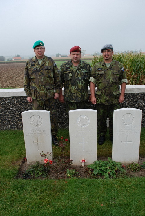 Příslušníci Vojenského historického ústavu Praha na vojenském hřbitově Tyne Cot u nového náhrobku vojína Náplavy (prostřední kámen). Zleva stojí major Jindřich Plescher, plukovník Pavel Löffler a nadpraporčík Leoš Krejča.