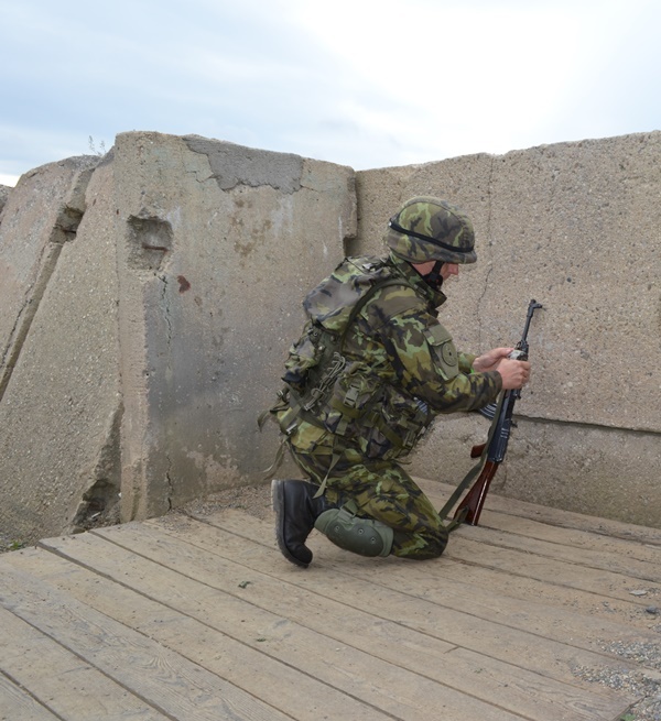 Voják v okopu při házení ručním granátem